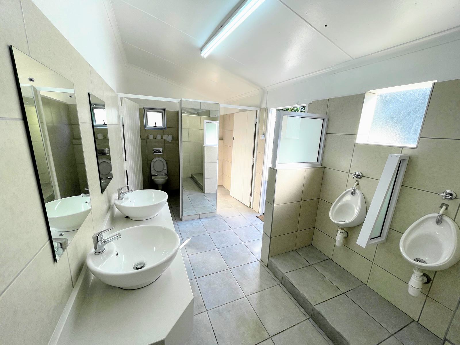 Bright, modern ablution facilities with showers and basins